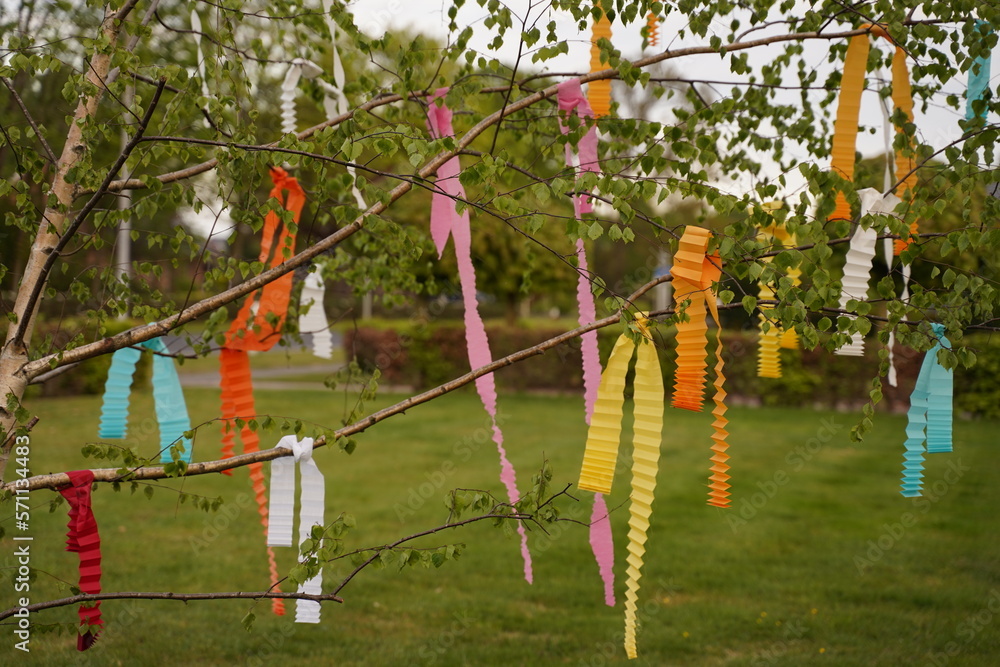 Multicolored ribbons on branches of a tree against the sky Multicolored ribbons on branches of a tree against the sky
