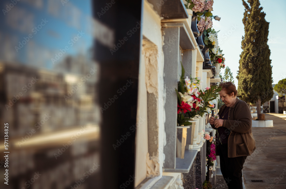 Side view of old lady in cemetery