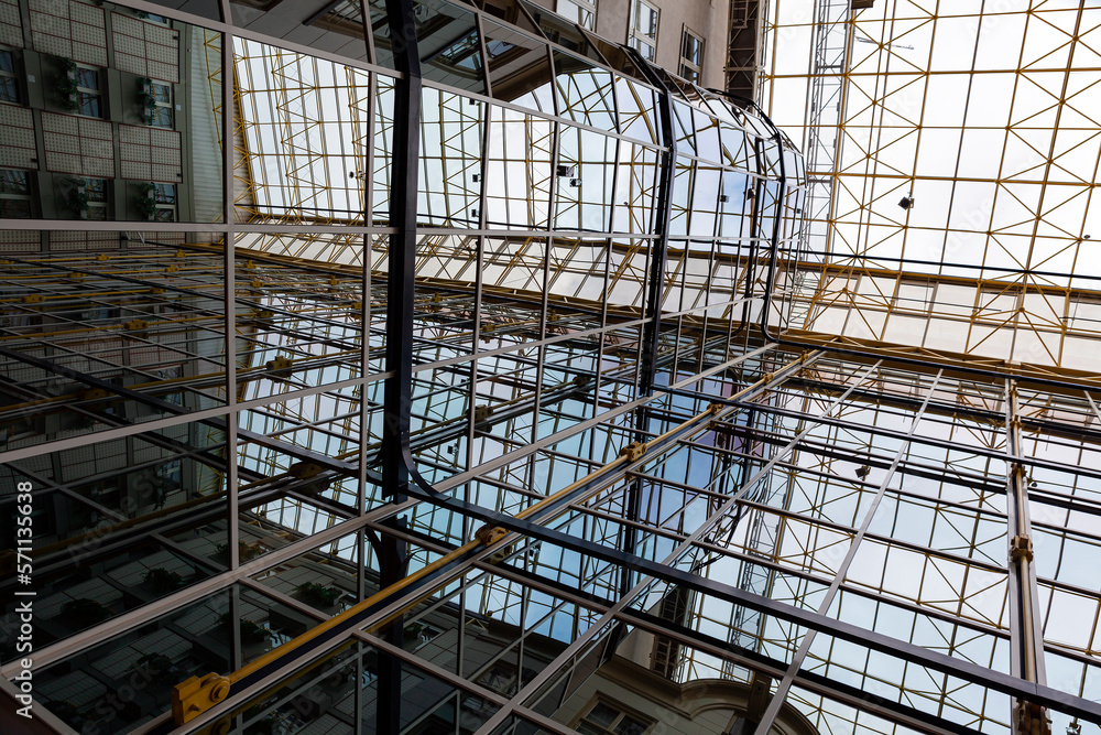 Iron construction with glass seen from below. Glass roof of a modern building