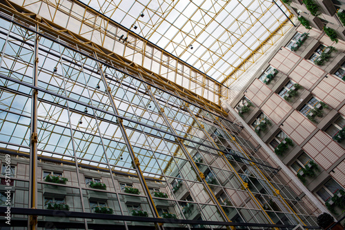 Iron construction with glass seen from below. Glass roof of a modern building