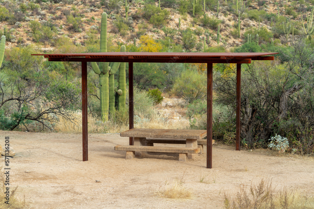 Park and outdoor awning in sabino national area in tuscon arizona with metal gazebo and cement bench for picnics.