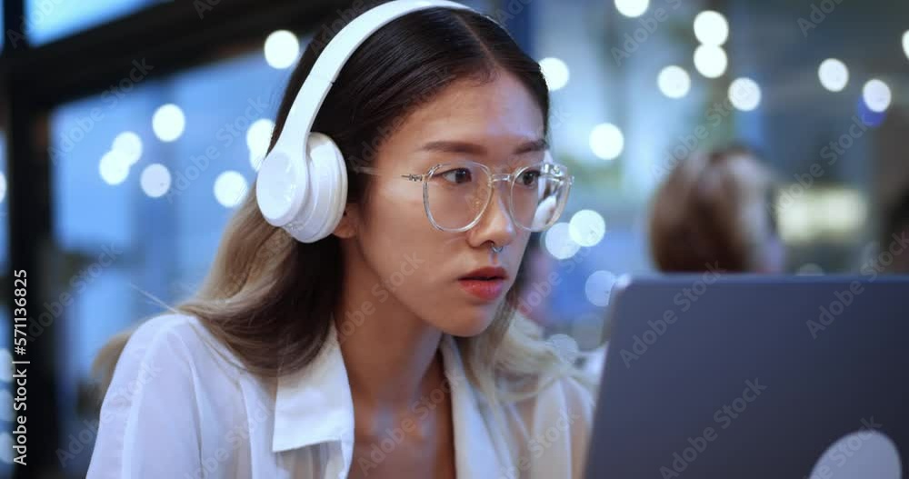 Young Asian Business Project Manager in Headphones Working on Laptop Computer in Busy Modern Office. Beautiful Diverse Multiethnic Female Specialist Concentrated Writing Business Strategy at Laptop Young Asian Business Project Manager in Headphones Working on Laptop Computer in Busy Modern Office. Beautiful Diverse Multiethnic Female Specialist Concentrated Writing Business Strategy at Laptop