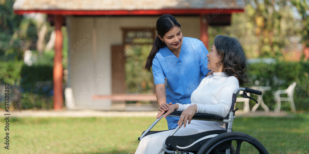 Elderly asian senior woman on wheelchair with nurse. Nursing home hospital garden concept Elderly asian senior woman on wheelchair with nurse. Nursing home hospital garden concept