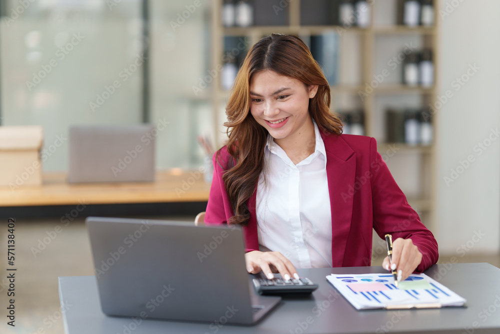 Beautiful Asian Business woman working at home office and analyze financial report document. Accounting and Finance concept. Beautiful Asian Business woman working at home office and analyze financial report document. Accounting and Finance concept.