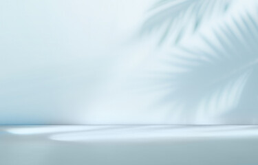 Blurred shadow from palm leaves on the light blue wall. Minimal abstract background for product presentation. Spring and summer.