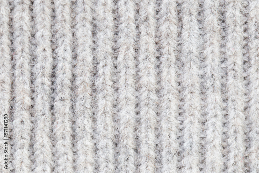 Knitwear background. White woolen fabric texture. Warm jumper closeup. Yarn textile backdrop. Handmade sweater texture. Gray cotton pattern. Knitwear background. White woolen fabric texture. Warm jumper closeup. Yarn textile backdrop. Handmade sweater texture. Gray cotton pattern.