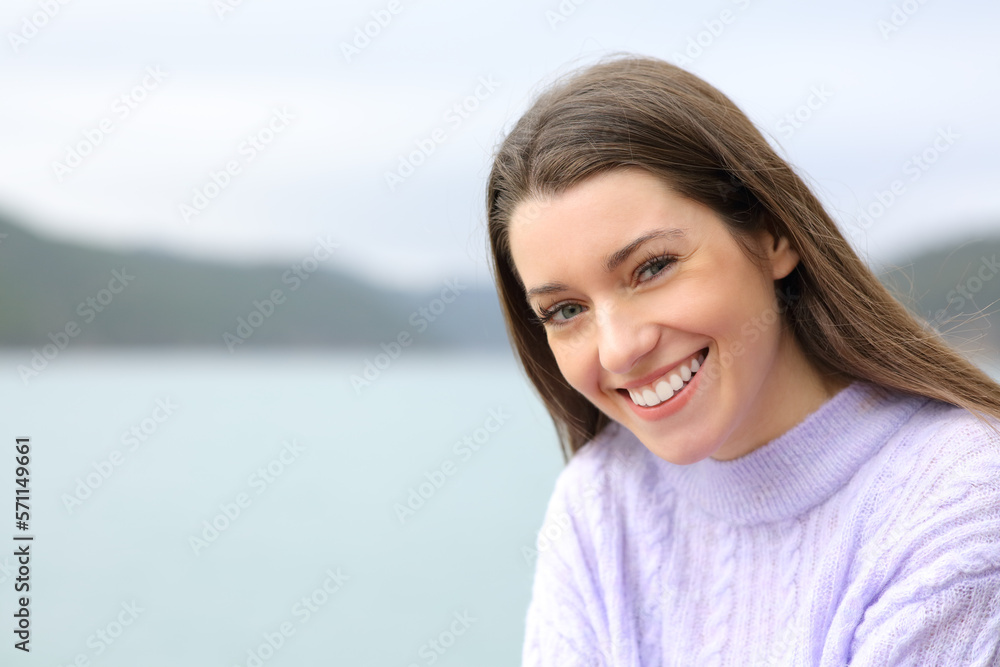 Happy teenager looking at camera in a lake