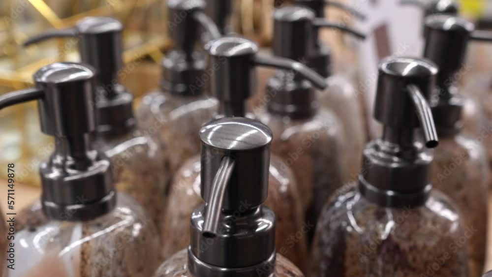 Stylish plastic bottles with a dispenser for liquid soap on a store shelf. Plastic dispensers close-up. Sale of design and interior items for the home. Stylish plastic bottles with a dispenser for liquid soap on a store shelf. Plastic dispensers close-up. Sale of design and interior items for the home.