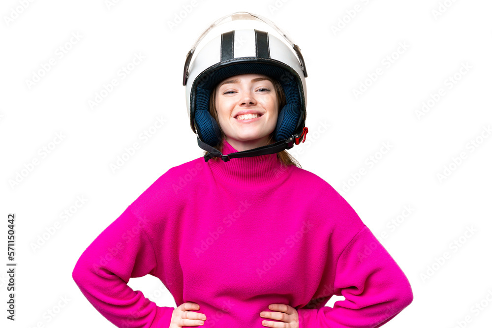 Young pretty woman with a motorcycle helmet over isolated chroma key background posing with arms at hip and smiling Young pretty woman with a motorcycle helmet over isolated chroma key background posing with arms at hip and smiling