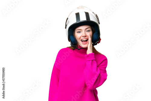 Young pretty woman with a motorcycle helmet over isolated chroma key background shouting with mouth wide open