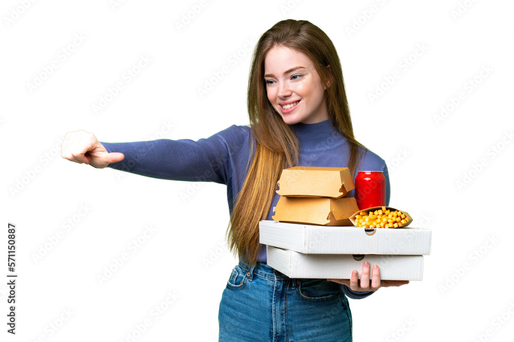 Young pretty woman holding pizzas and burgers over isolated chroma key background giving a thumbs up gesture Young pretty woman holding pizzas and burgers over isolated chroma key background giving a thumbs up gesture