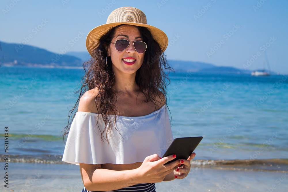 young tourist woman with digital tablet on the beach
