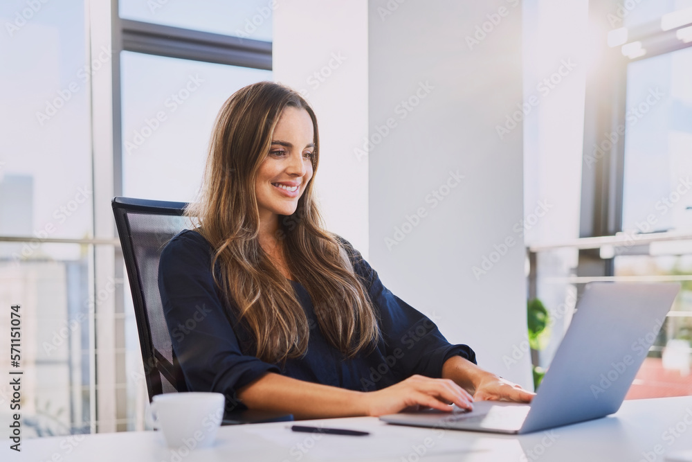 Businesswoman working on laptop sitting at office desk Businesswoman working on laptop sitting at office desk