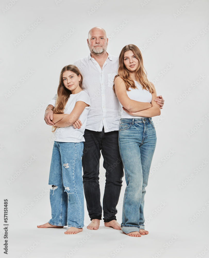 Daughter with arms crossed standing by father against white background Daughter with arms crossed standing by father against white background