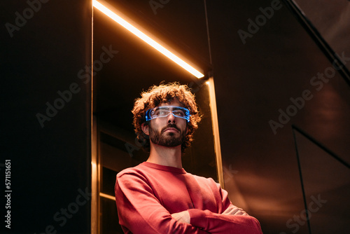 Young man wearing smart eyeglasses standing in elevator photo