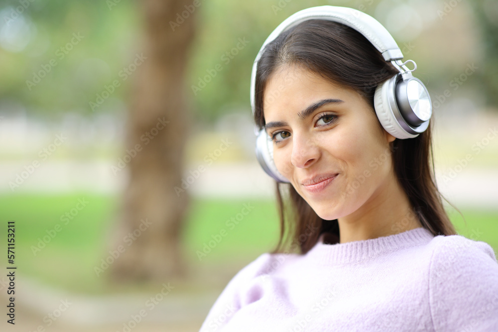 Happy woman with headphones looks at you Happy woman with headphones looks at you