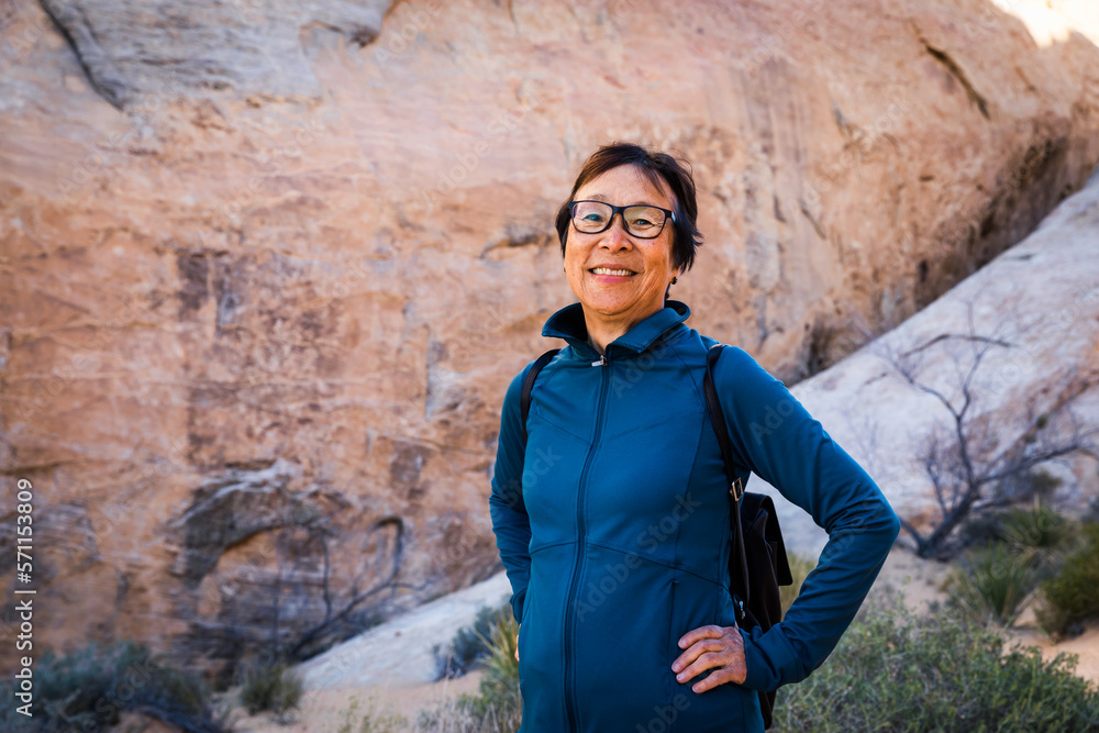 Portrait of Smiling Senior Asian Woman hiking in the desert landscape Portrait of Smiling Senior Asian Woman hiking in the desert landscape