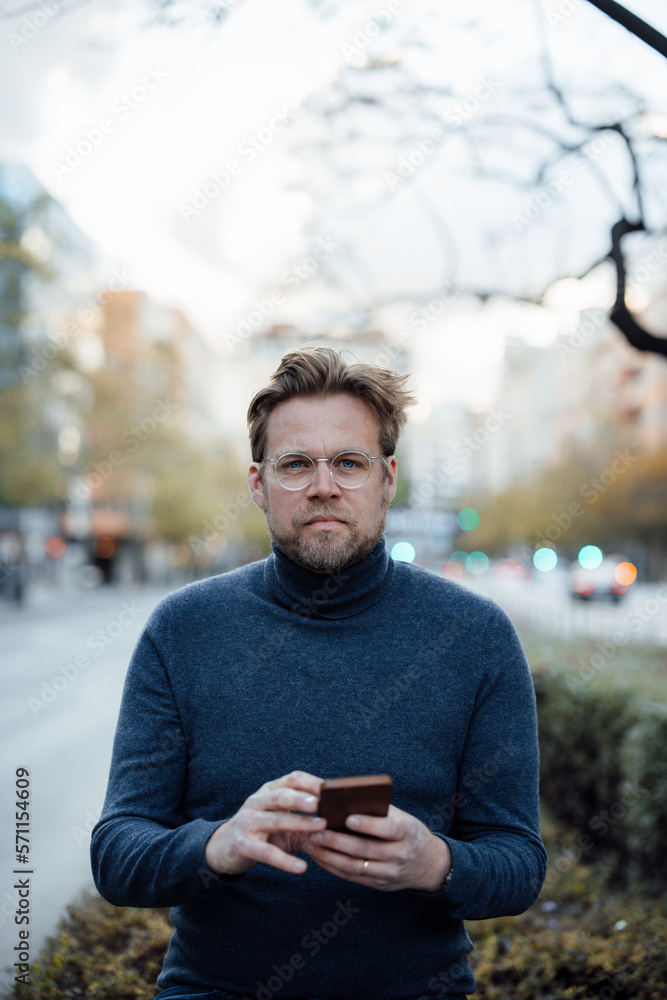 Man with smart phone wearing eyeglasses Man with smart phone wearing eyeglasses