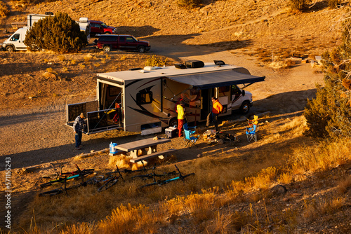 Guys setting up camp in a motorhome.