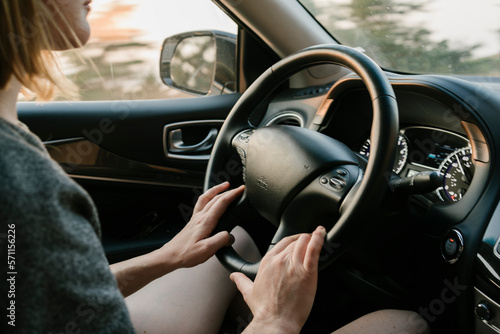 Inside view of woman driving in Big Sur at sunset