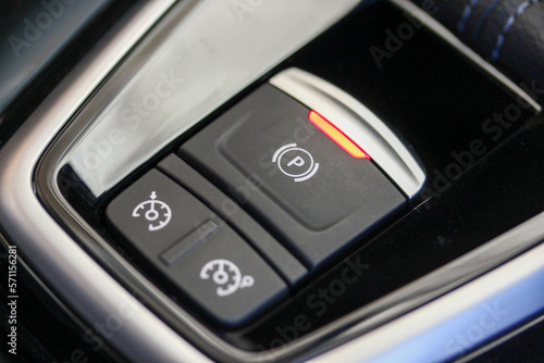Cruise control and parking brake buttons in a new luxury vehicle