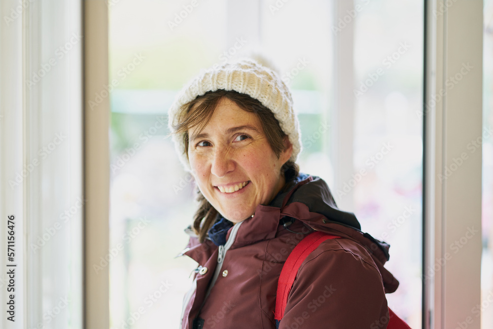 portrait of a woman with a white hat on her head and a warm jacket wit portrait of a woman with a white hat on her head and a warm jacket wit