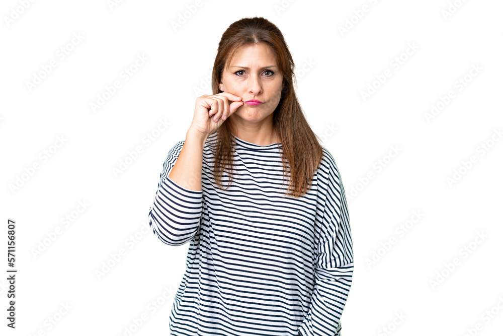 Middle age woman over isolated background showing a sign of silence gesture Middle age woman over isolated background showing a sign of silence gesture