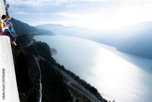 Two men laughing and smiling while drinking beer sunset on portaledge