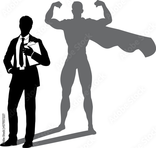 A superhero business man revealed by his shadow silhouette as a super hero in a cape