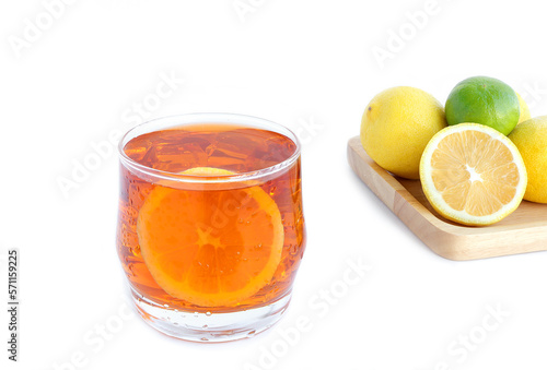 Glass of tasty cold ice tea and fresh lemon on white background. lemon against a background with copy space