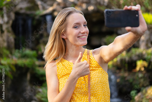 woman showing thumb up and taking selfie photo © auremar