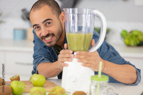 young preparing a fruit smoothie