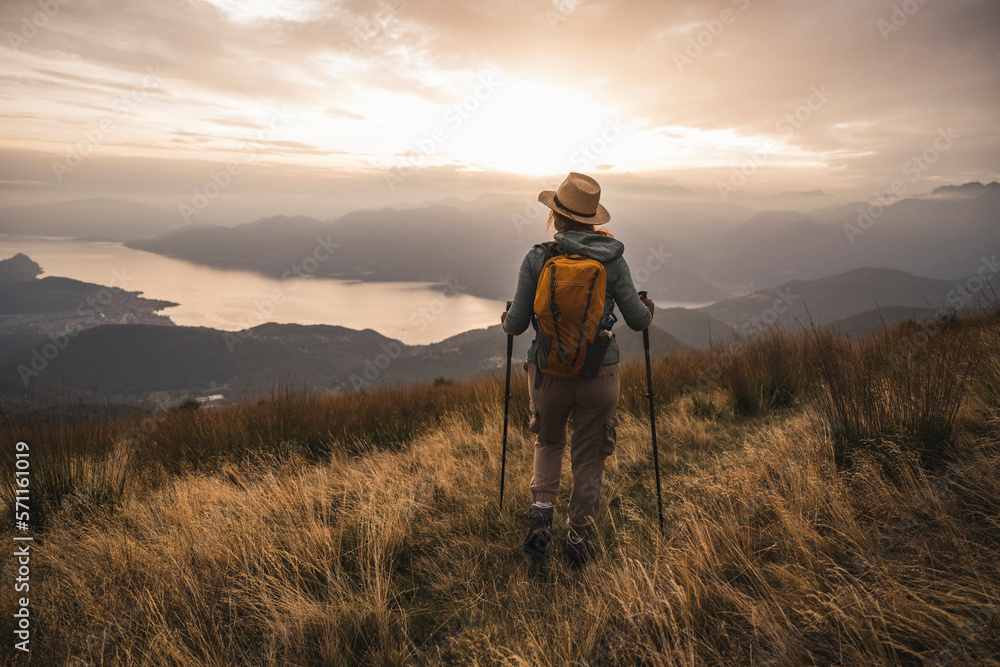 Mature woman with hat standing on mountain Mature woman with hat standing on mountain