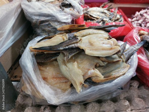 Dry salted cod fish or ikan asin for sale at market, is fish cured with dry salt and thus preserved for later eating photo