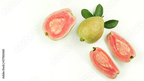 Fresh pink guava fruit, pieces and leaves isolated on white background.