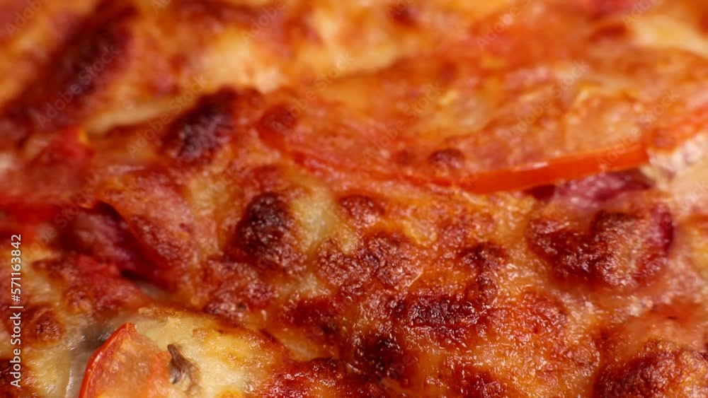 Delicious fresh pizza with cheese, ham, tomatoes close-up Delicious fresh pizza with cheese, ham, tomatoes close-up
