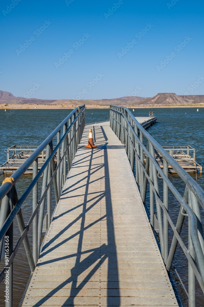 A very long boardwalk surrounded by shrubs in Elephant Butte, New Mexico