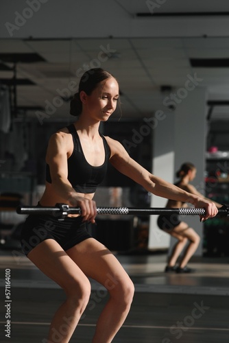Sports. Woman at the gym doing stretching exercises.