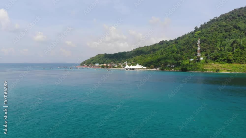 Aerial view of an island surrounded by green mountains in Malaysia Aerial view of an island surrounded by green mountains in Malaysia