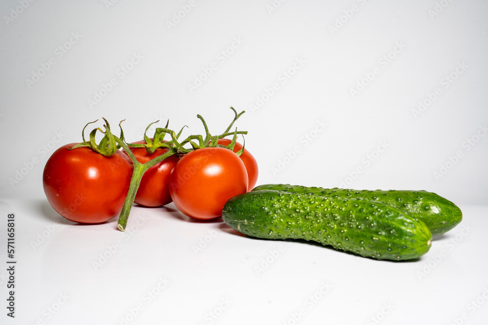Photo tomato and cucumber on a white background selective focus copy space Photo tomato and cucumber on a white background selective focus copy space