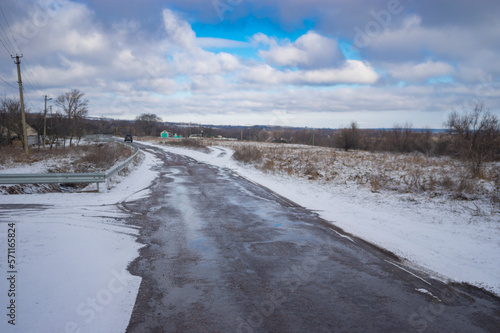 Winter landscape with country road covered with snow leading to Mishurin rog village, Dniproperovsk oblast, Ukraine