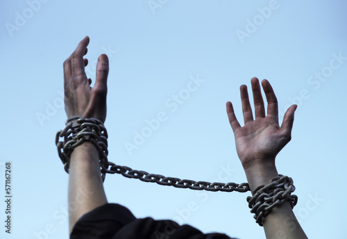 Praying man with shackled hands