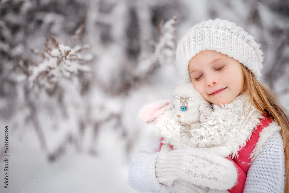 Beautiful little girl with long hair. Little girl in the winter forest. Girl in a hat. Girl in a Zara sheepskin coat. A little girl hugs a toy hare. Winter. Snow. Tender baby. Baby portrait. Beautiful little girl with long hair. Little girl in the winter forest. Girl in a hat. Girl in a Zara sheepskin coat. A little girl hugs a toy hare. Winter. Snow. Tender baby. Baby portrait.