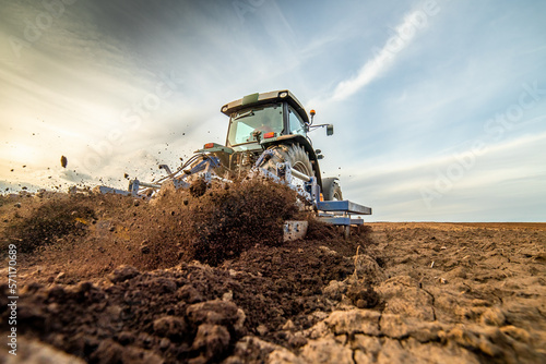 The art of farming, tractor tilling the soil for a successful planting season