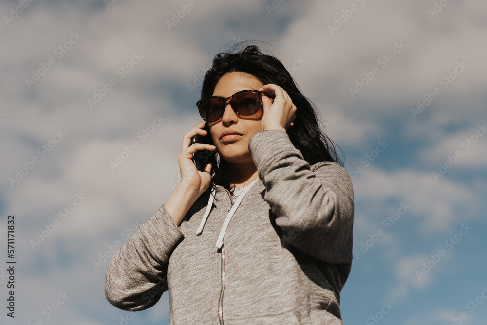 portrait of beautiful hispanic woman talking on the phone portrait of beautiful hispanic woman talking on the phone