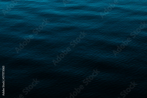 Dark calm water photo with blue shades