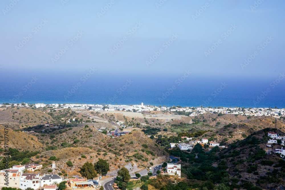 View of a white village on the horizon from the mountain with the sea in the background in the Canary Islands.
