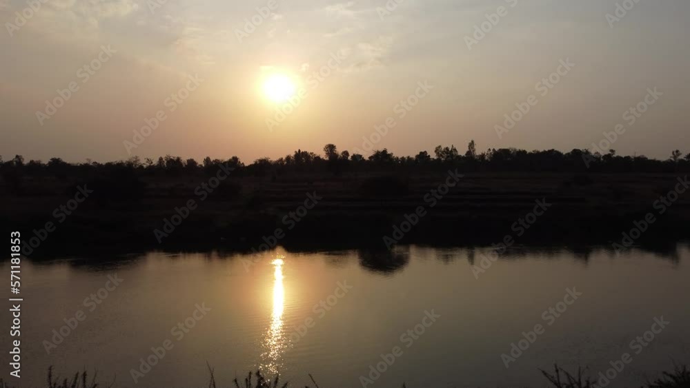 Drone Taking off. 4k. Showing Sunset on a River Bank with Bushes and Nature. Drone Taking off. 4k. Showing Sunset on a River Bank with Bushes and Nature.