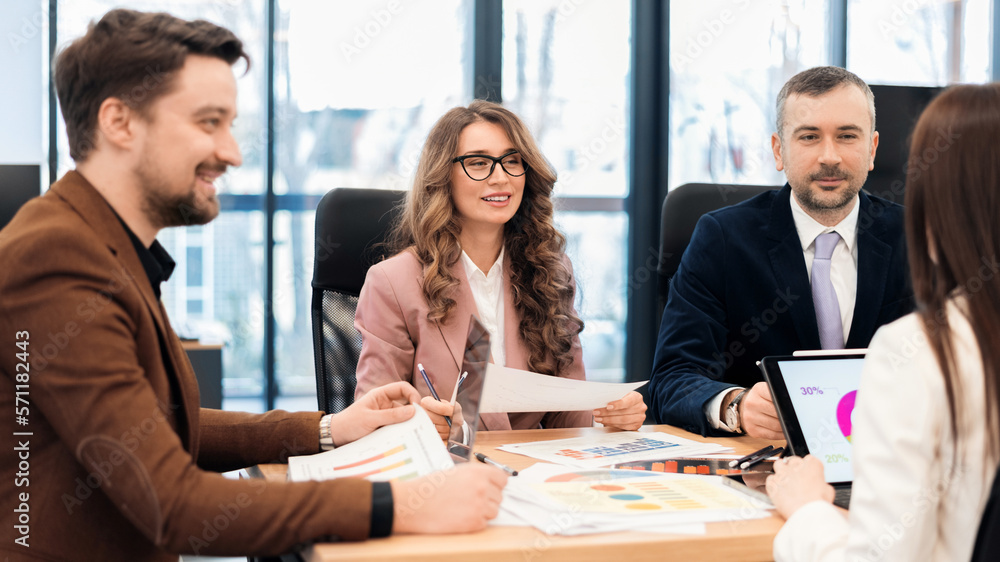 Business meeting in an office, workers discussing business affairs. Gadgets and papers on the table