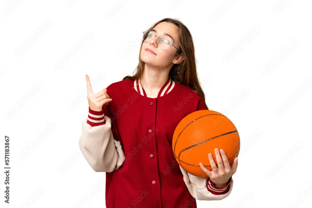 Teenager girl playing basketball over isolated chroma key background pointing up a great idea Teenager girl playing basketball over isolated chroma key background pointing up a great idea
